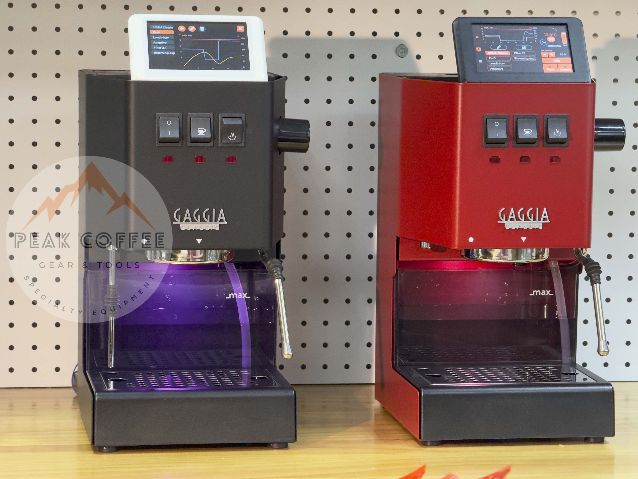 Two Gaggia Classic espresso machines, one black and one red, each fitted with a Gaggiuino touchscreen showing a live brew graph